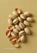 Close up of shelled and unshelled pistachio nuts on fabric