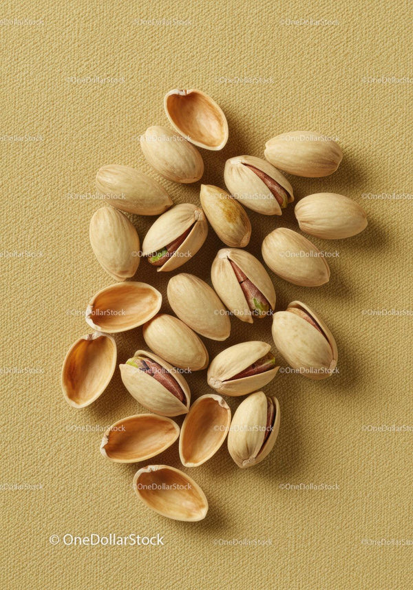 Close up of shelled and unshelled pistachio nuts on fabric