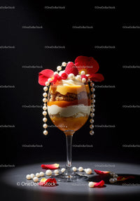 Layered dessert with raspberries and pearls on black
