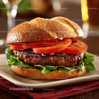 Gourmet Beef Burger with Fresh Vegetables on a Rustic Plate