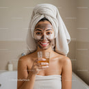 Woman with Facial Mask Holding Glass of Tea in Spa Setting