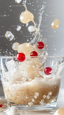 Splashing Water with Red Berries and Ice Cubes in a Glass