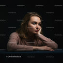 Contemplative Young Woman in Casual Pink Sweater Against Dark Background