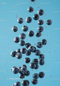 Fresh blueberries suspended in clear water droplets
