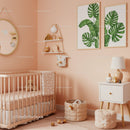 Cozy Nursery Room with Baby Crib and Tropical Wall Art