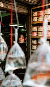 Young woman peeks from doorway of traditional market shop