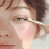 Close-Up of Young Woman Applying Pink Eyeshadow with Brush