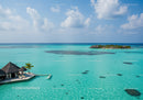 Turquoise Ocean with Overwater Bungalows and Palm Trees at Paradise Island