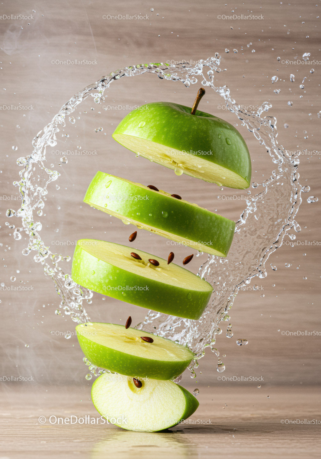 Fresh green apple slices suspended in water splash