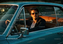 Young Man in Sunglasses Driving Classic Vintage Car in Sunset Light