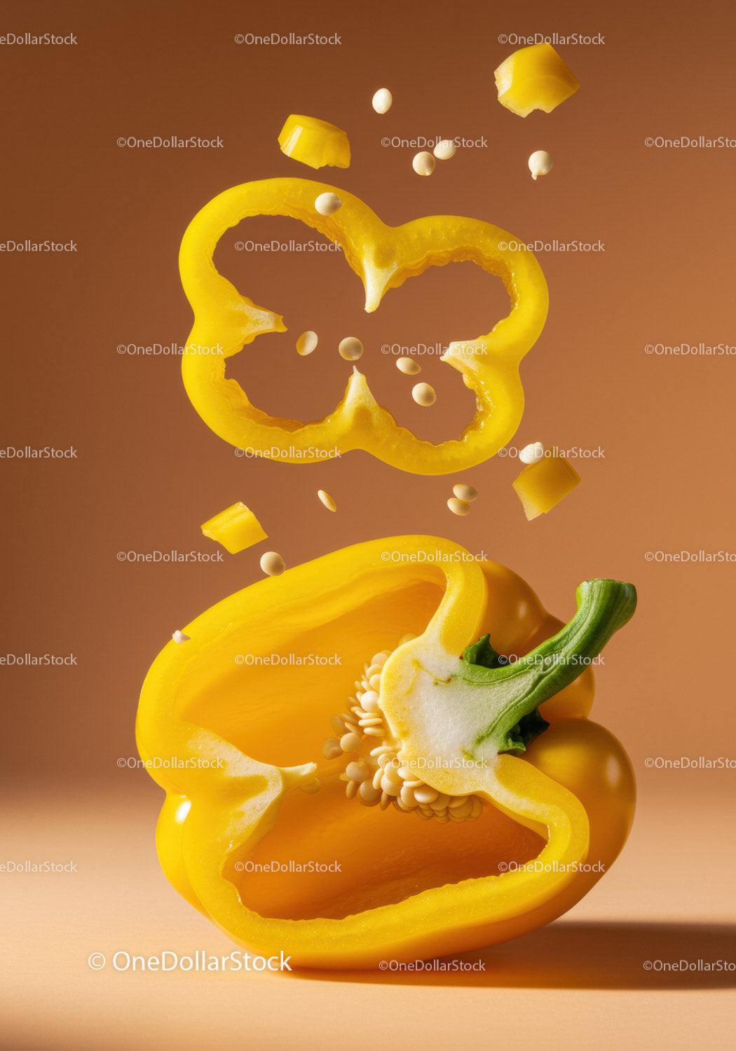 Fresh yellow bell pepper halves with seeds falling