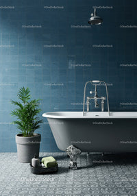 Elegant freestanding bathtub with lush green plant