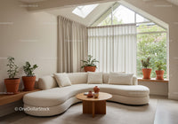 Modern curved sofa in bright cozy living room interior