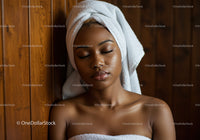 Relaxing Young Woman with Towel and Spa Atmosphere in Warm Wooden Room