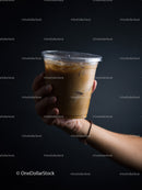 Refreshing Iced Coffee in Hand with Dark Background