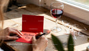 Writing a heartfelt love note with red wine on wood