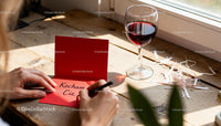 Writing a heartfelt love note with red wine on wood