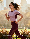 Fit woman jogging energetically in urban park