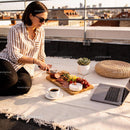 Woman enjoying rooftop charcuterie board and coffee break