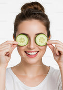 Young Woman with Cucumber Slices on Eyes for Relaxation and Beauty