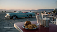 Vintage Car Near Beachside Dining Scene at Sunset