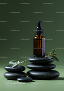 Amber Glass Dropper Bottle with Herbal Leaves on Black Stones