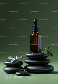 Amber Glass Dropper Bottle with Herbal Leaves on Black Stones