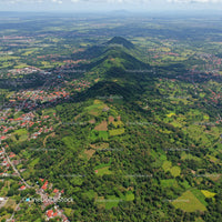 Lush Green Mountainous Landscape with Forests and Village