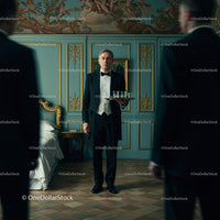 Elegant Waiter in a Luxurious Vintage Setting Serving Drinks