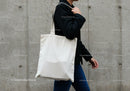 Person Walking with Plain White Canvas Tote Bag