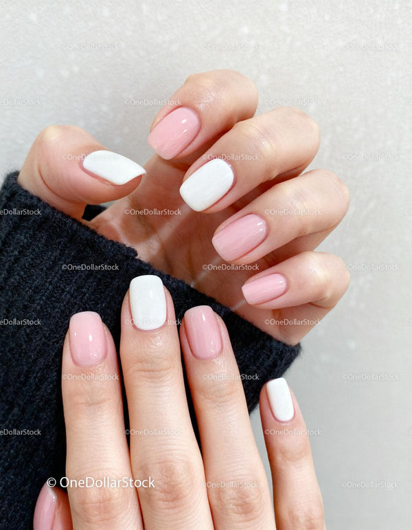 Well-groomed hands with soft pink and white nails
