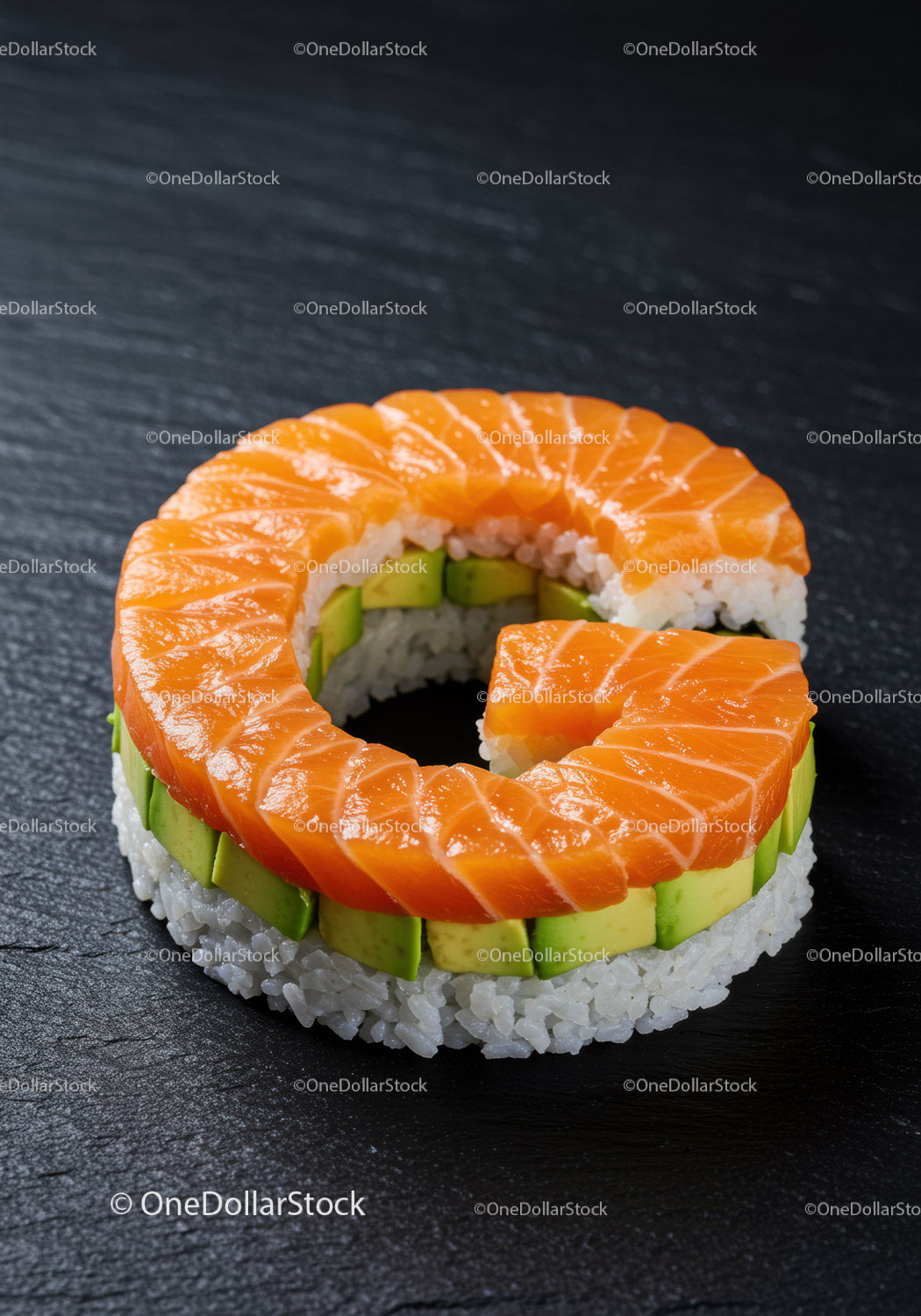 Fresh salmon and avocado sushi ring on slate plate