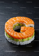 Fresh salmon and avocado sushi ring on slate plate