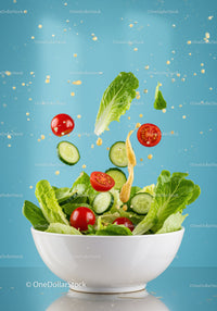 Fresh garden salad with flying vegetables and dressing