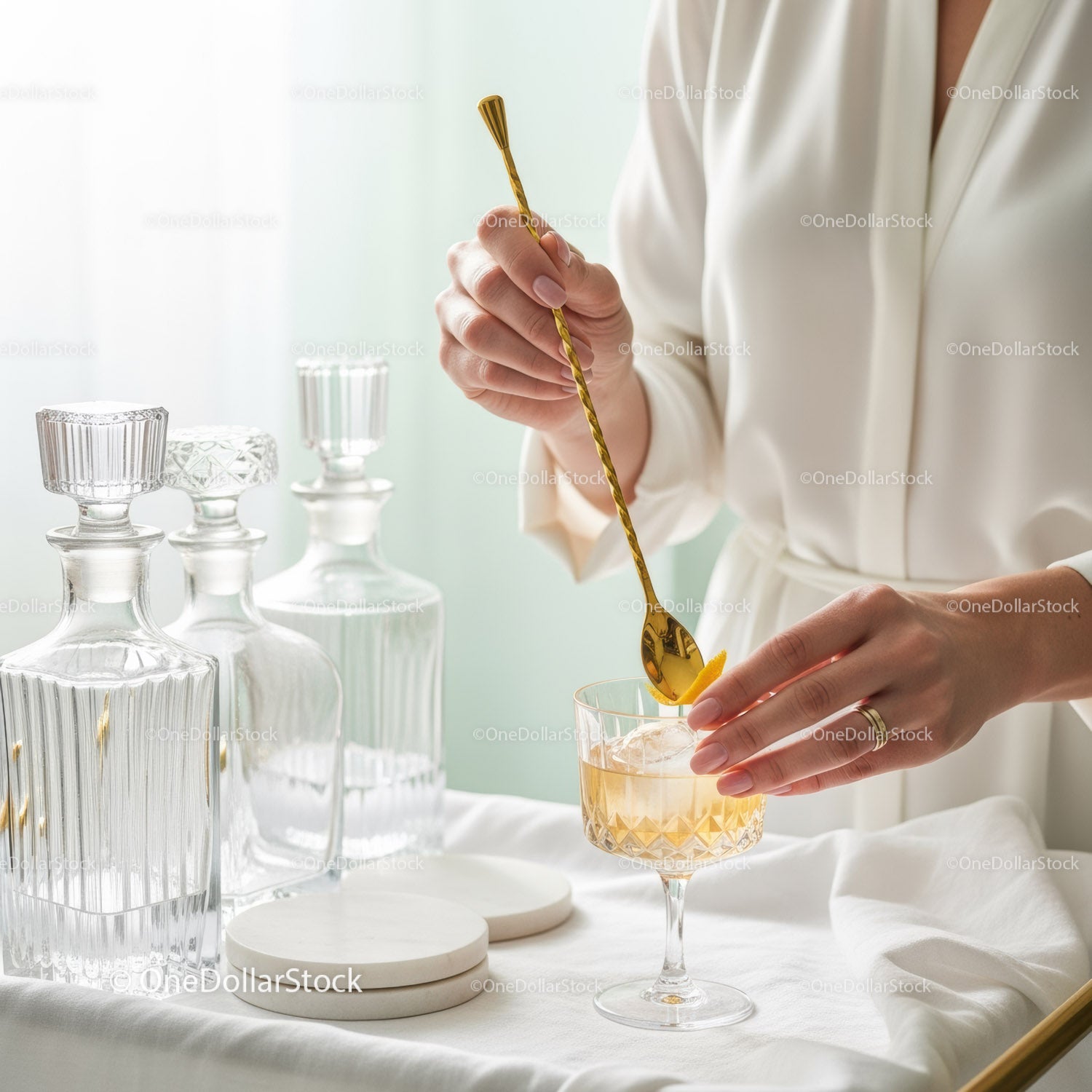 Elegant Woman Pouring Drink with Gold Spoon in Sophisticated Glass