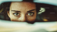 Close-up of Green-eyed Woman with Freckles and Sunshine