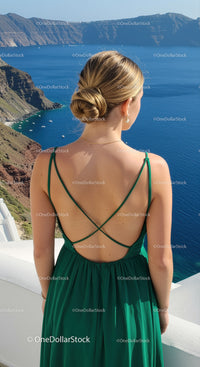 Woman in green dress enjoying coastal landscape view