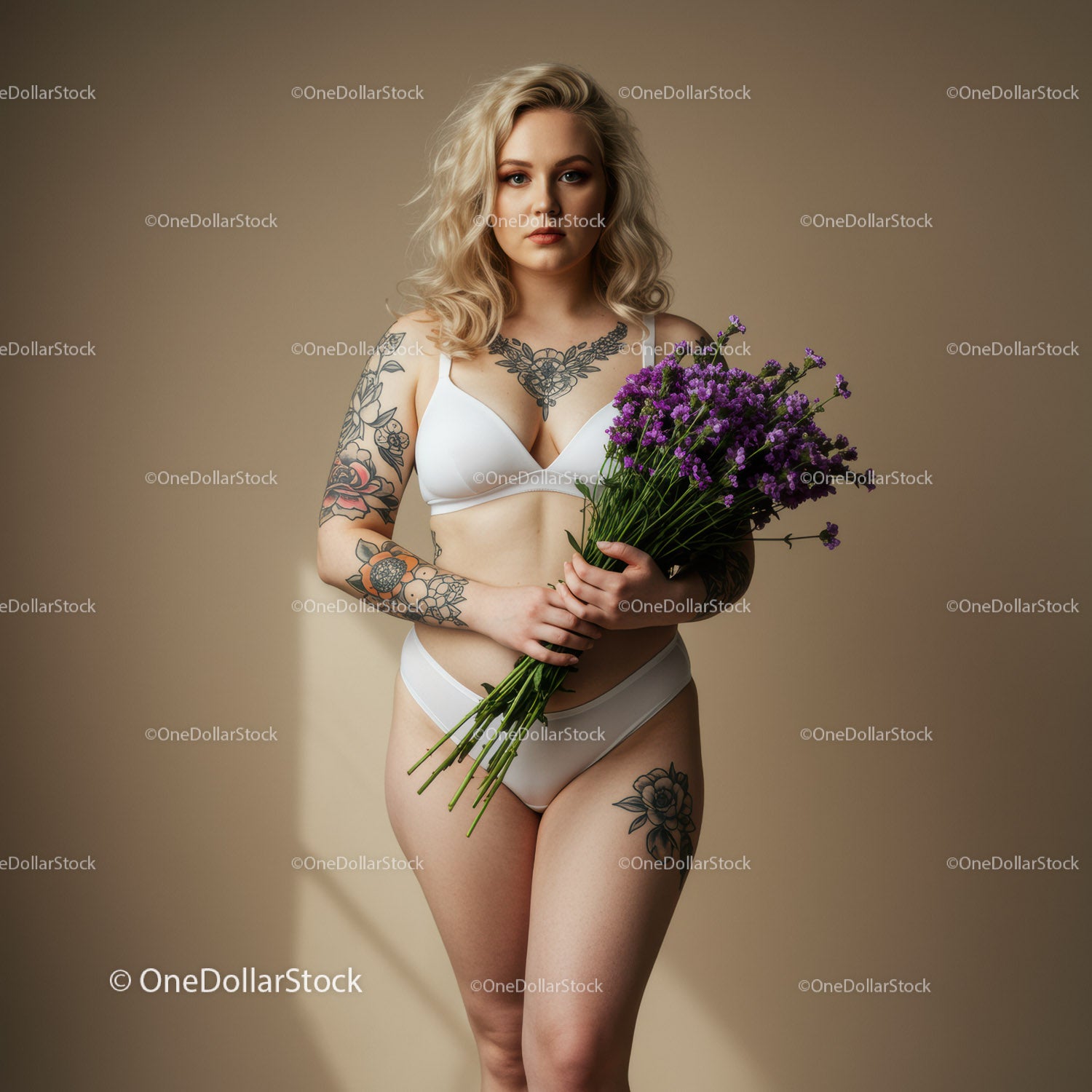 Tattooed Woman in White Lingerie Holding Purple Flowers Studio Portrait