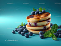 Stack of Blueberry Pancakes with Fresh Mint and Berry Topping