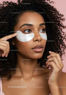 Beautiful Woman with Face Masks Applying Skincare Under Pink Background