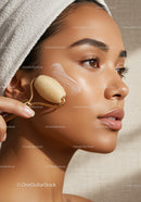 Close-Up of Young Woman Using Facial Roller for Skin Care