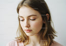 Young Woman with Natural Makeup and Soft Expression for Beauty Photography