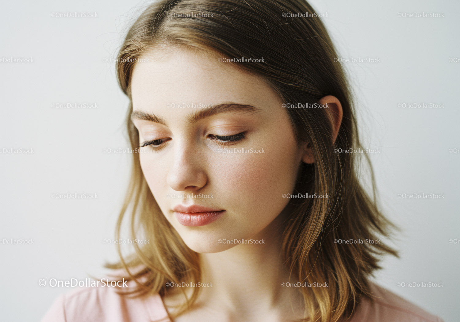 Young Woman with Natural Makeup and Soft Expression for Beauty Photography
