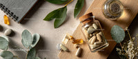 Assorted Capsules and Tablets with Herbal Leaves and Glass Bottle