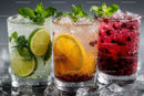 Colorful Fruit Infused Sparkling Drinks with Ice and Fresh Garnishes