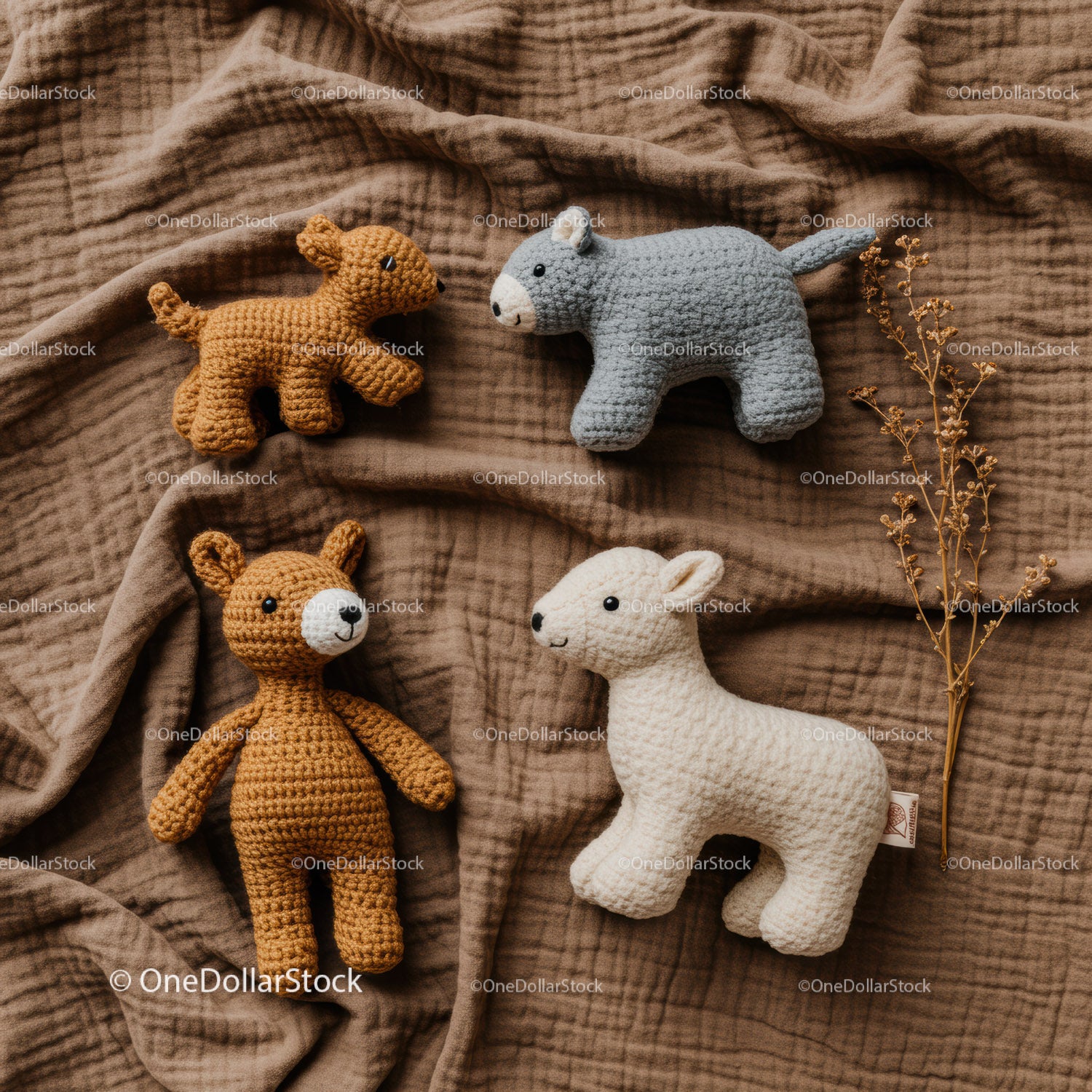 Handmade amigurumi animal toys on textured fabric