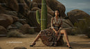 Elegant Model in Brown Suit Posing Amidst Desert Rocks