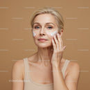 Mature Woman Applying Facial Cream for Skin Care Routine