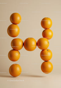 Floating Oranges Arranged in Letter H on Beige Background