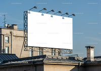 Blank urban billboard glowing under clear sky